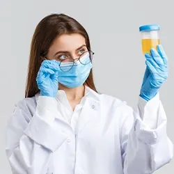 female doctor checking a urine in a container