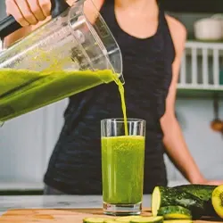 A woman pouring a detox drink
